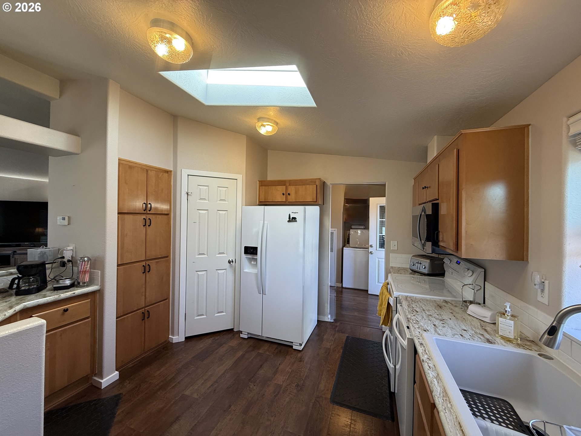 3050 Knott Terrace Coos Bay, OR 97420 - Photo 23 of 24 a kitchen with a refrigerator and a sink