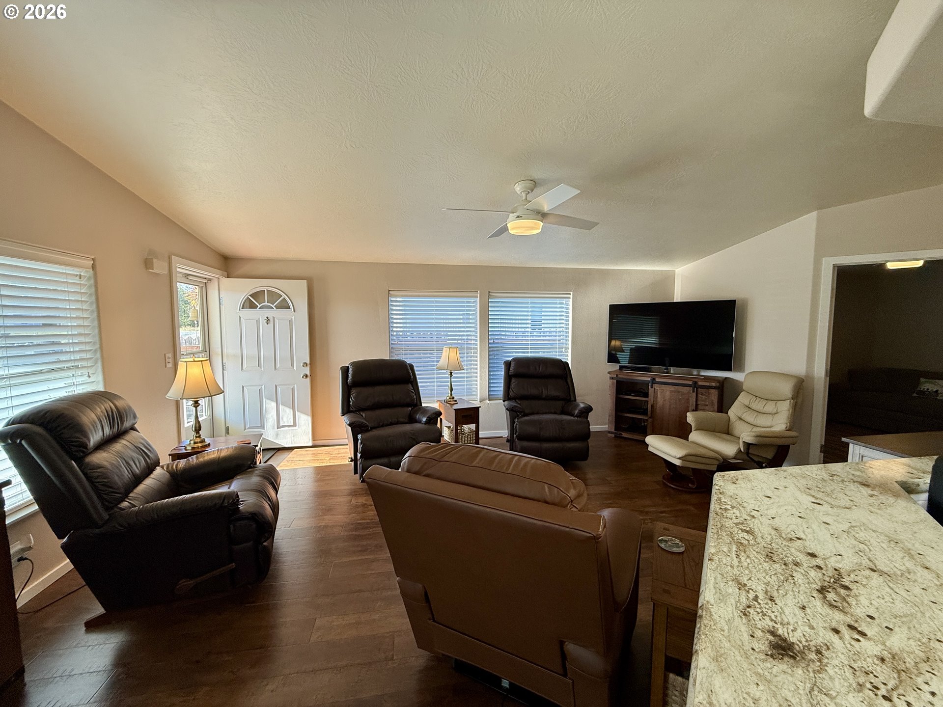 3050 Knott Terrace Coos Bay, OR 97420 - Photo 5 of 24 a living room with fireplace furniture and a flat screen tv