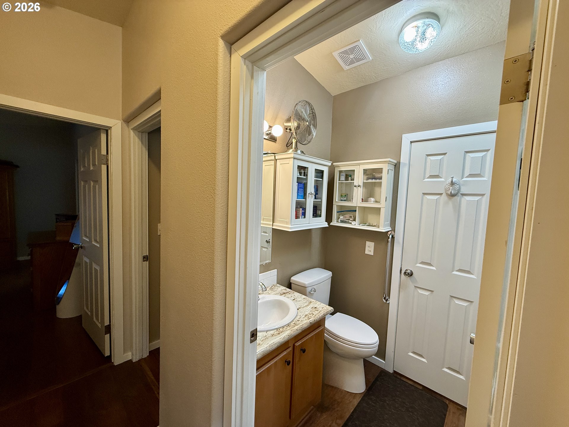 3050 Knott Terrace Coos Bay, OR 97420 - Photo 9 of 24 a bathroom with a toilet a sink and mirror