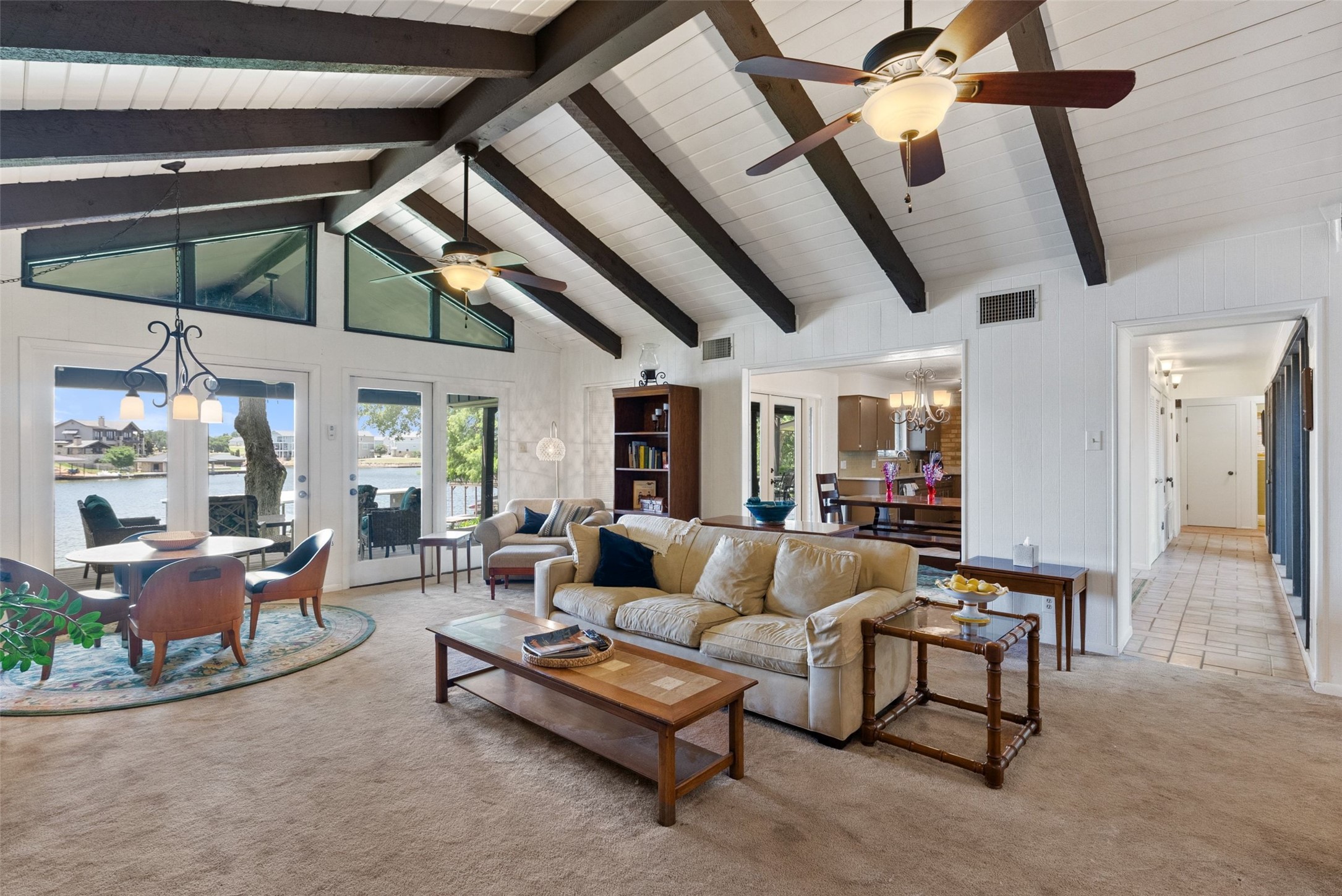 141 Perry Lane Kingsland, TX 78639 - Photo 16 of 40 A spacious living area with exposed beam vaulted ceilings and direct access to waterfront outdoor living.