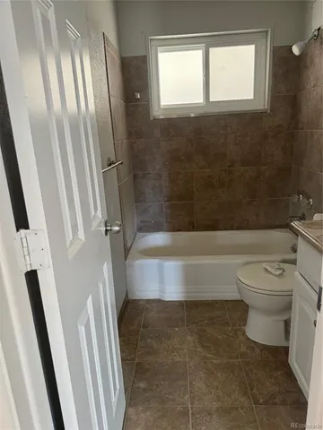 a bathroom with a toilet and a bathtub