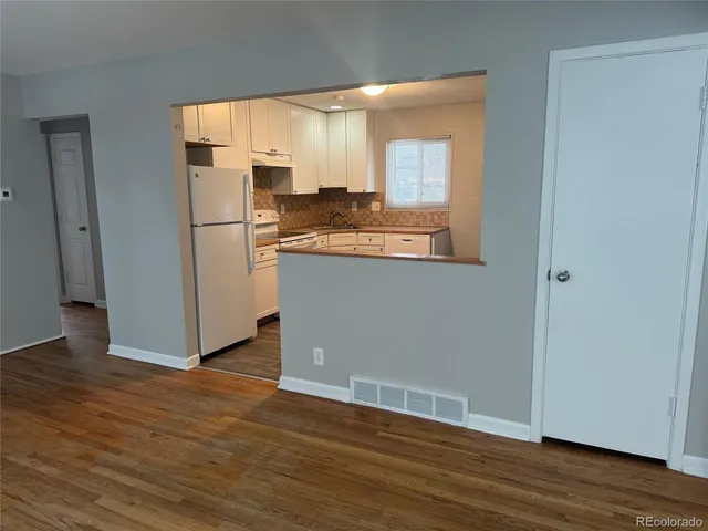 a view of a kitchen with wooden floor