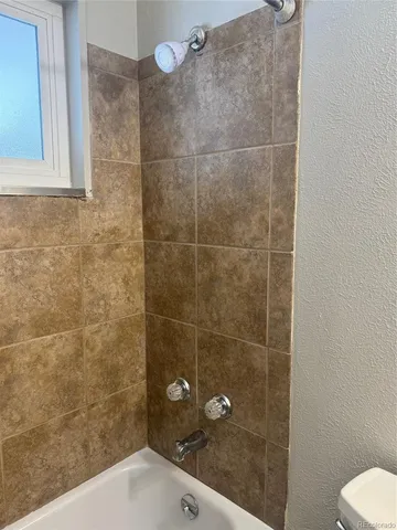 a bathroom with a shower and toilet