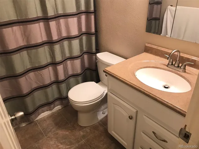 a white toilet sitting next to a bathroom sink
