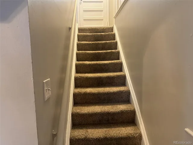 a view of staircase with white walls