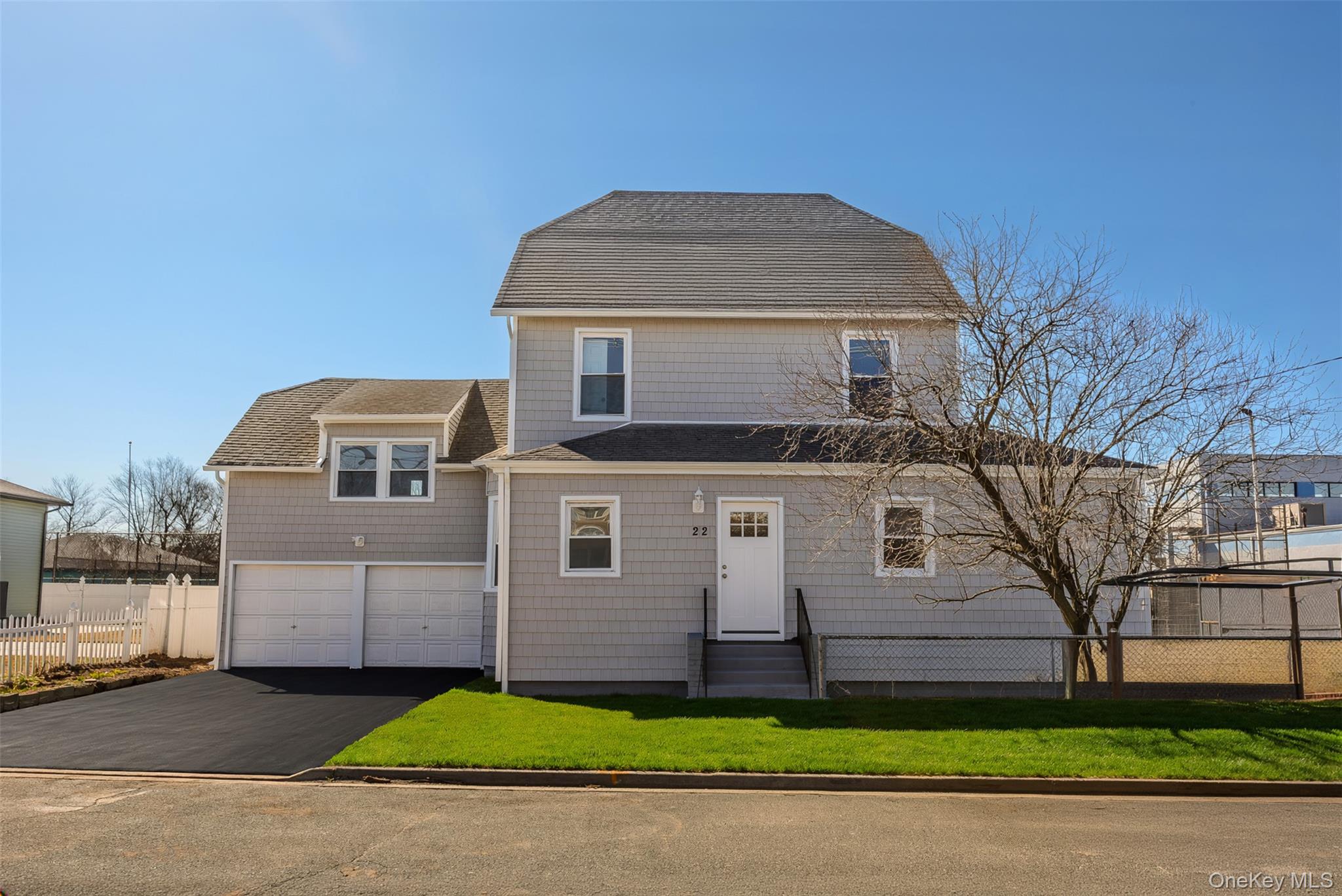 22 Colonial Avenue Freeport, NY 11520 - Photo 1 of 41 a front view of a house with a yard and garage