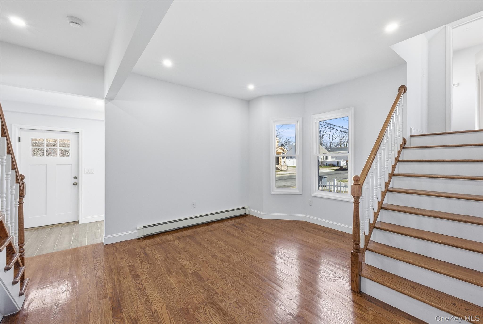 22 Colonial Avenue Freeport, NY 11520 - Photo 11 of 41 a view of entryway with wooden floor and stairs