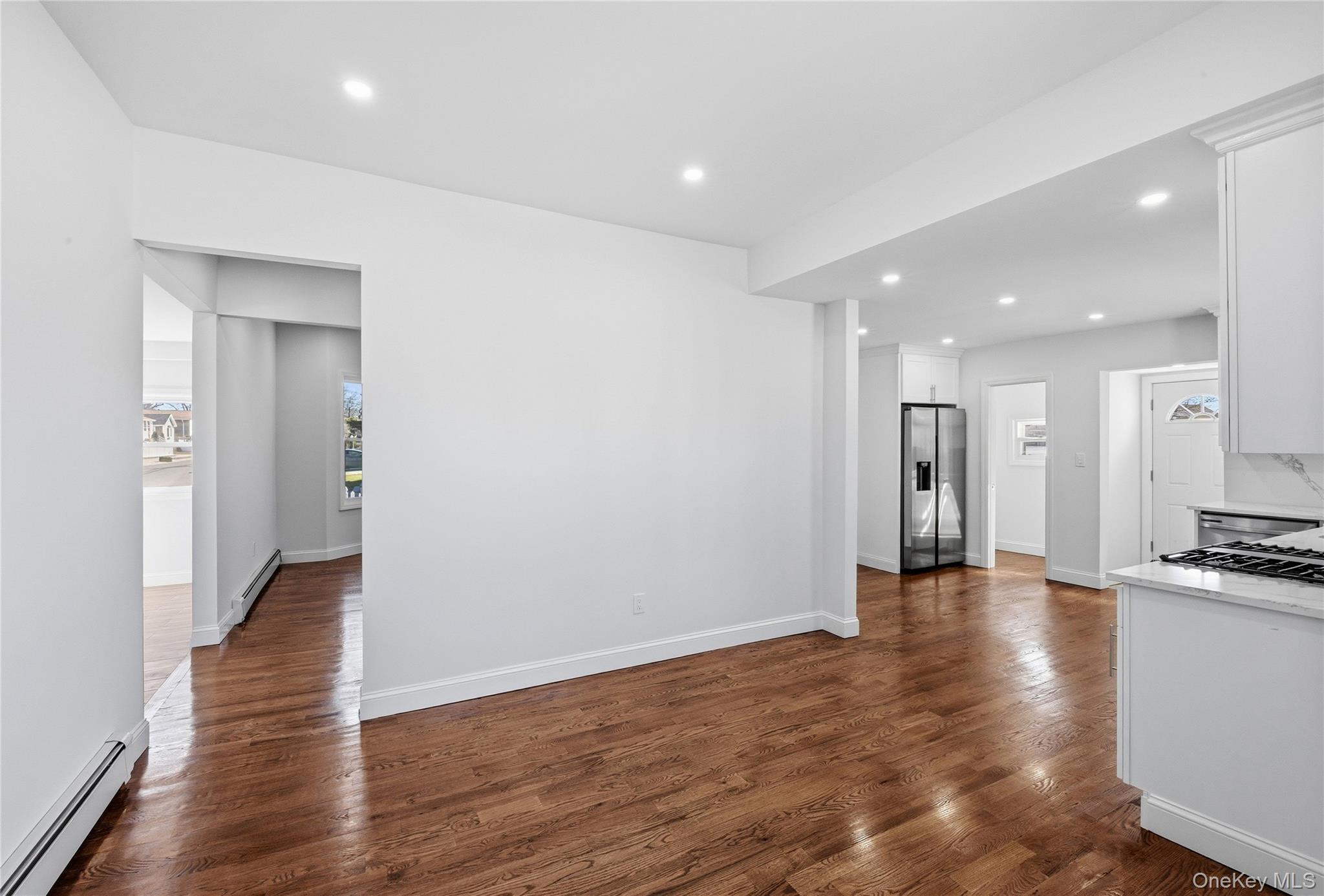 22 Colonial Avenue Freeport, NY 11520 - Photo 14 of 41 a view of a hallway with wooden floor kitchen and a window