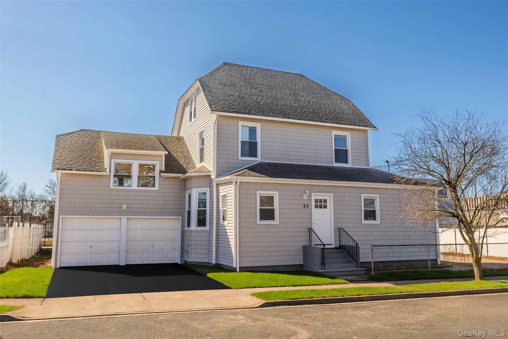 22 Colonial Avenue Freeport, NY 11520 - Photo 2 of 41 a front view of a house with a yard