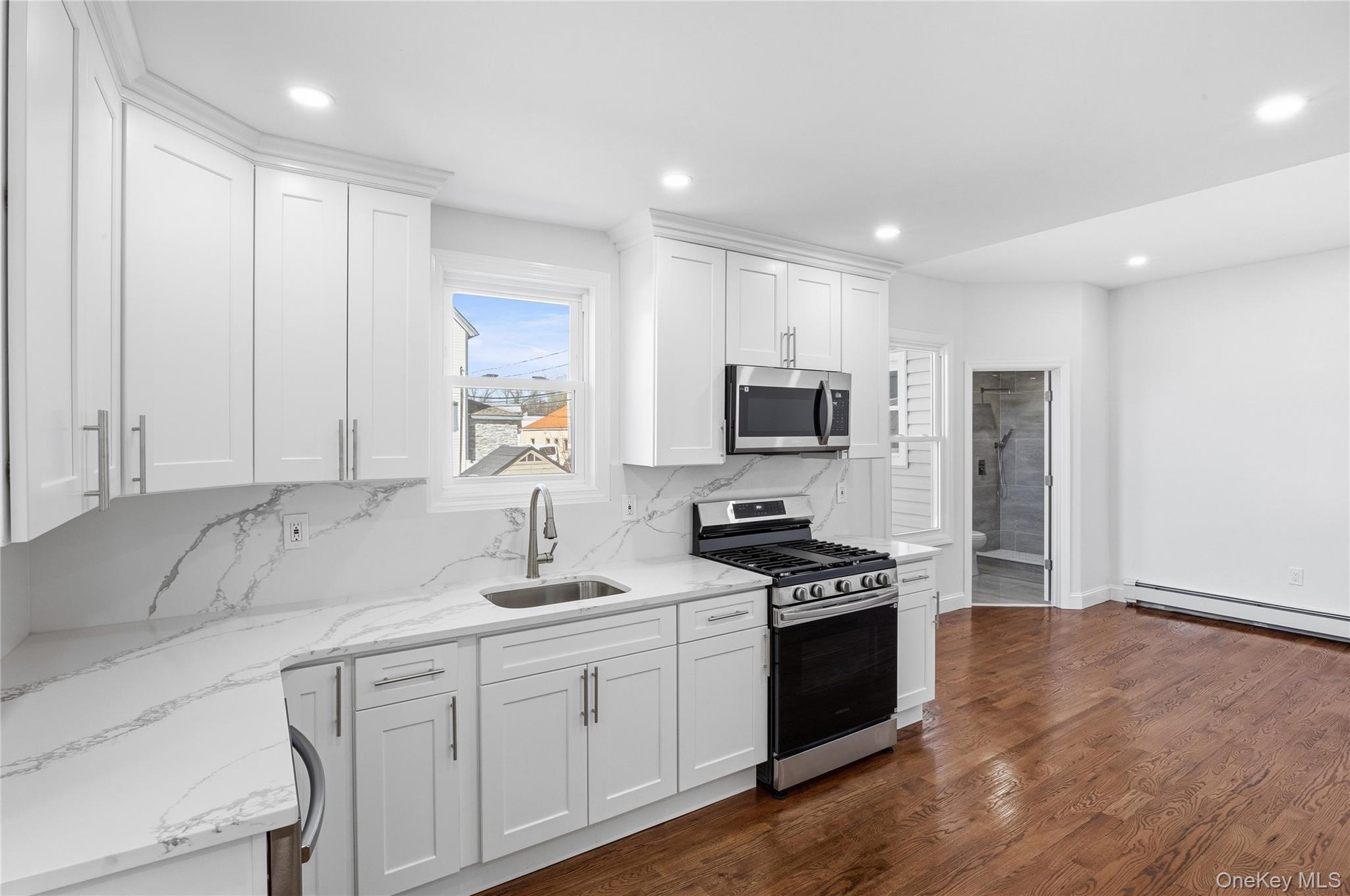 22 Colonial Avenue Freeport, NY 11520 - Photo 21 of 41 a kitchen with sink a microwave and cabinets