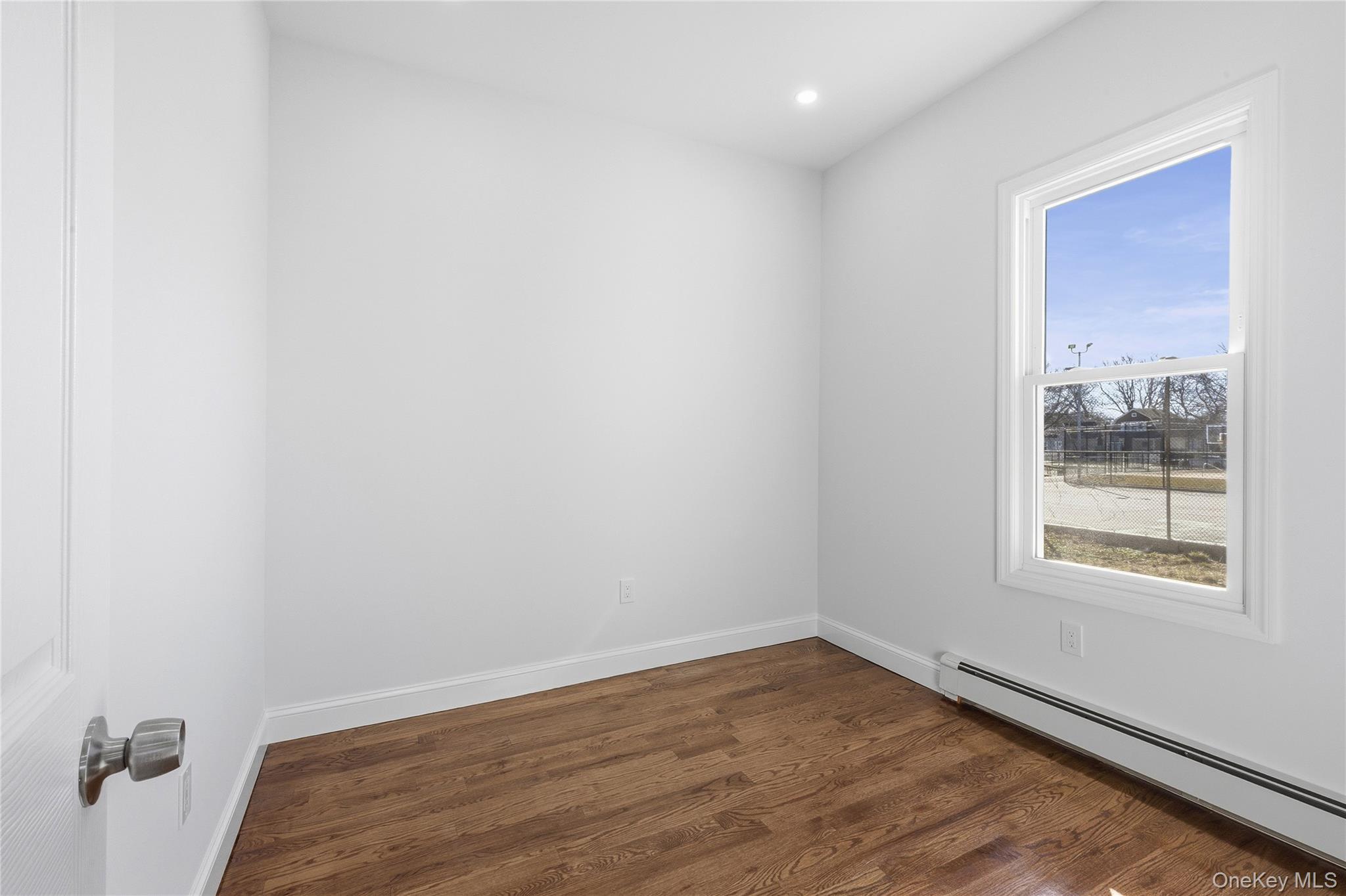 22 Colonial Avenue Freeport, NY 11520 - Photo 24 of 41 a view of empty room with wooden floor and fan