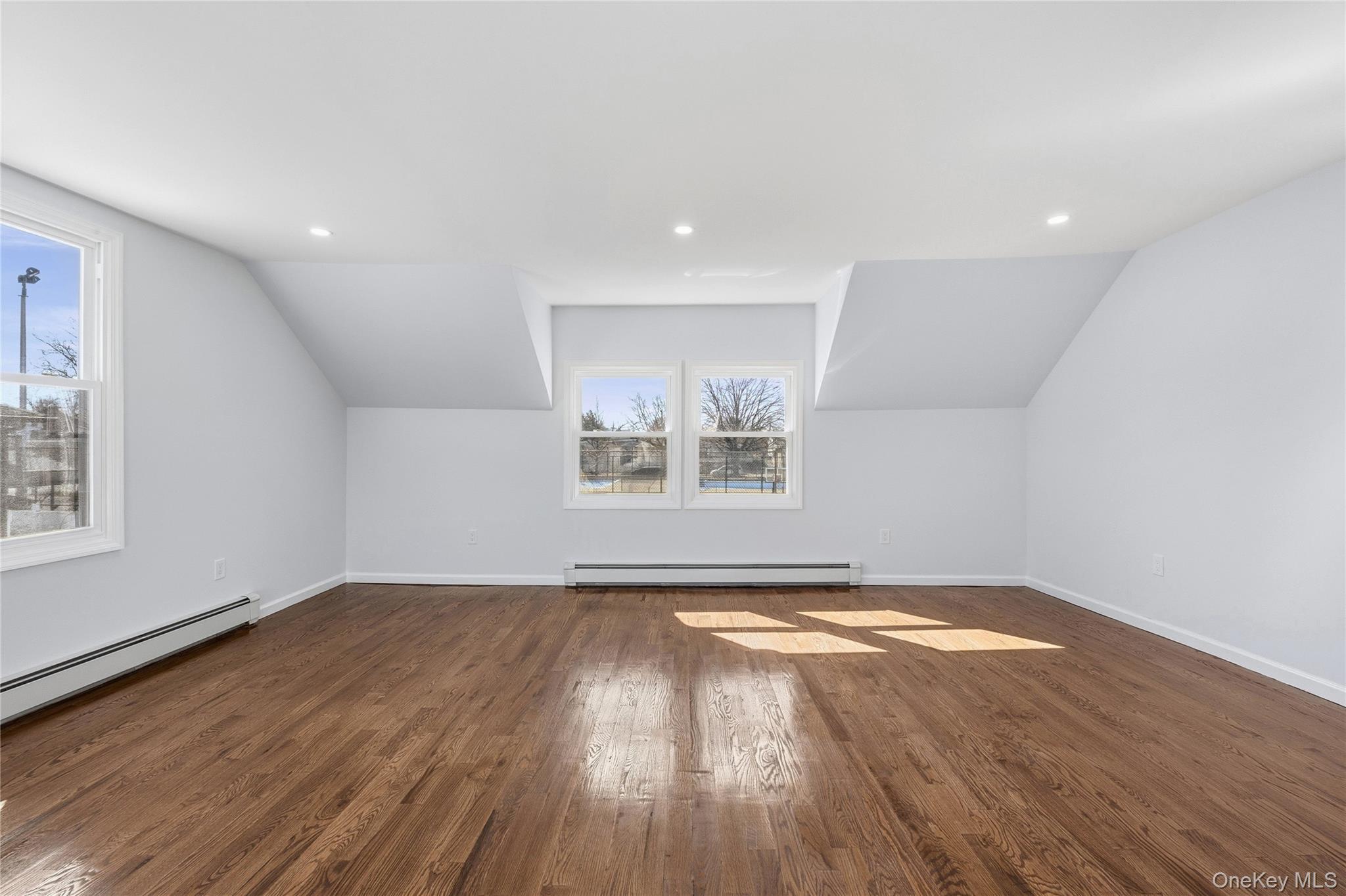 22 Colonial Avenue Freeport, NY 11520 - Photo 26 of 41 a view of empty room with wooden floor and fan