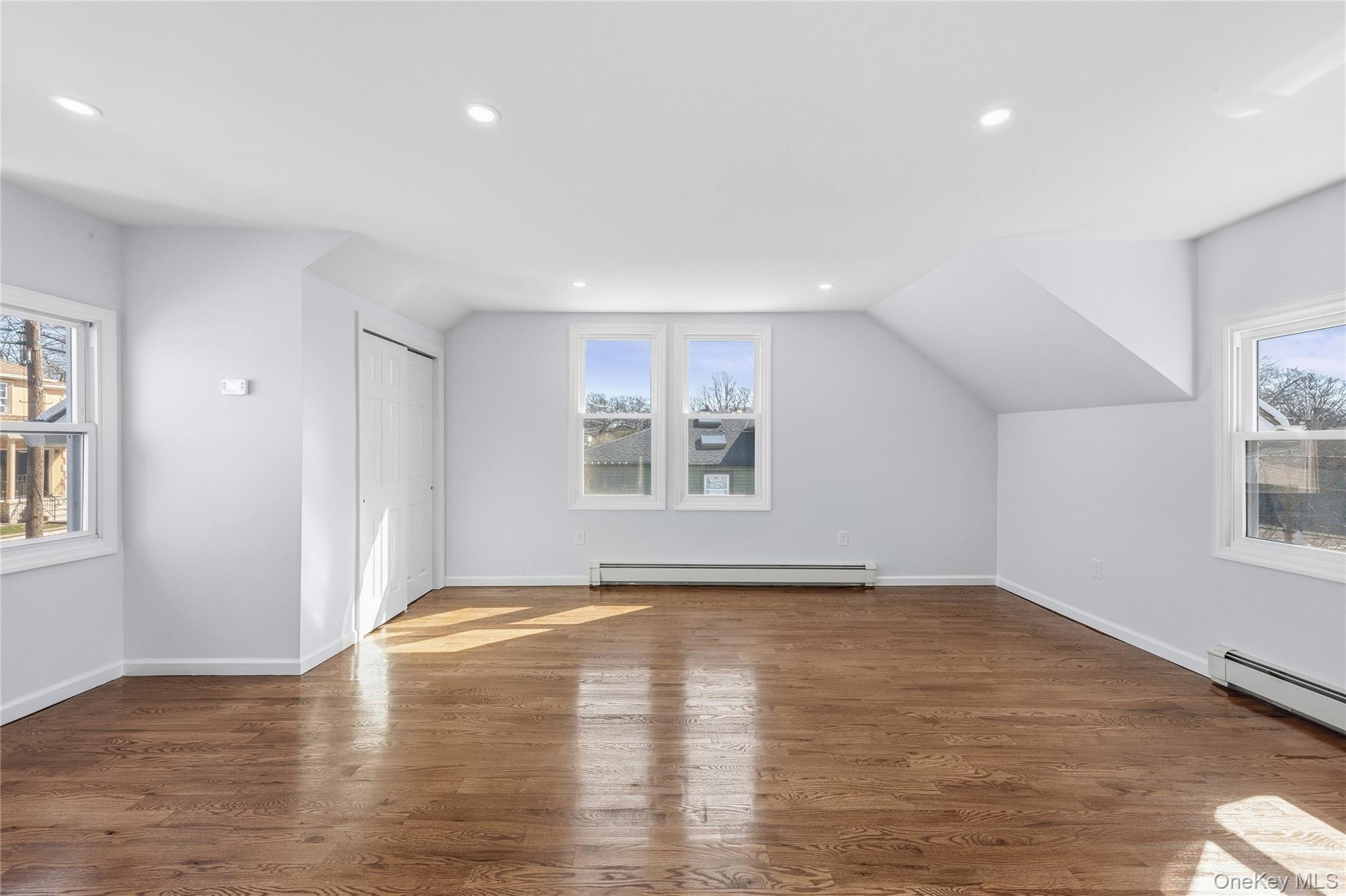 22 Colonial Avenue Freeport, NY 11520 - Photo 27 of 41 a view of an empty room with window and wooden floor