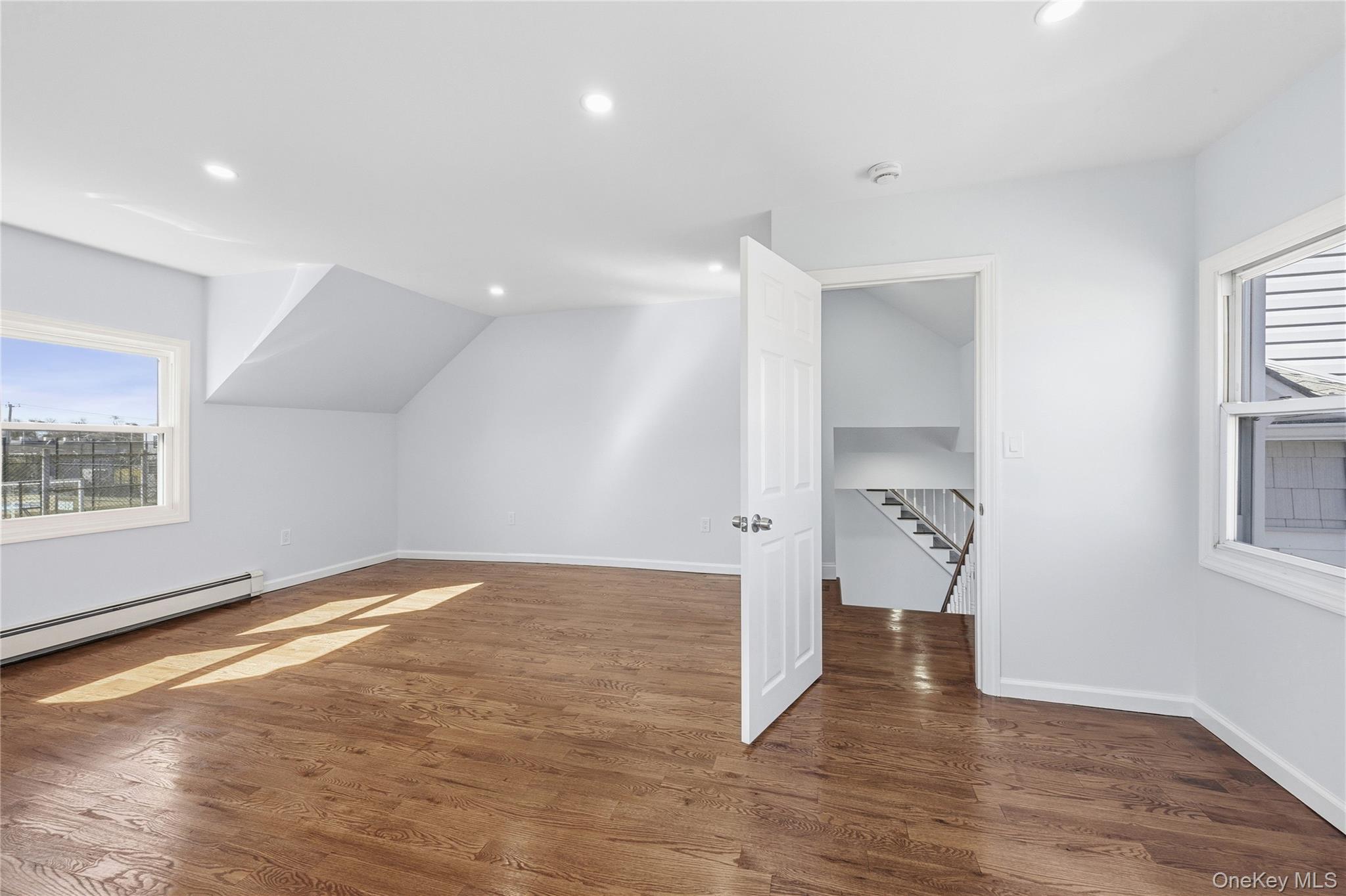 22 Colonial Avenue Freeport, NY 11520 - Photo 28 of 41 an empty room with wooden floor and windows