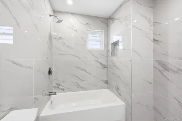 a bathroom with a bathtub and shower