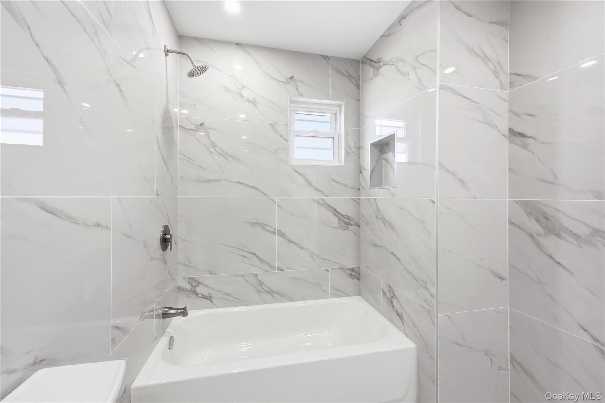 22 Colonial Avenue Freeport, NY 11520 - Photo 30 of 41 a bathroom with a bathtub and shower