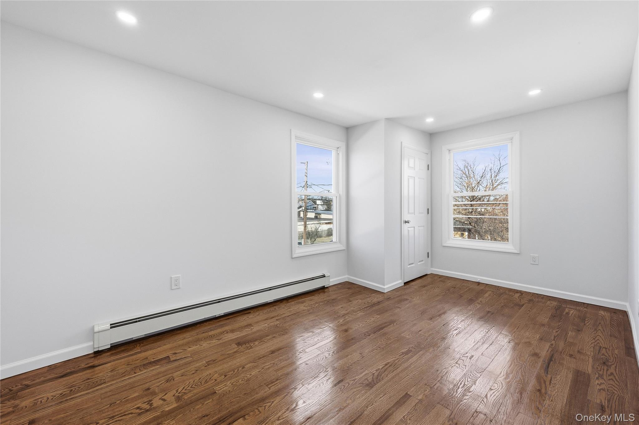 22 Colonial Avenue Freeport, NY 11520 - Photo 32 of 41 a view of an empty room with wooden floor and a window