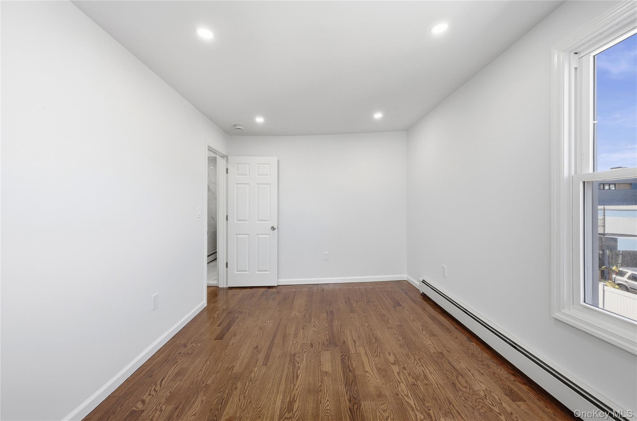 22 Colonial Avenue Freeport, NY 11520 - Photo 33 of 41 a view of room with window and wooden floor
