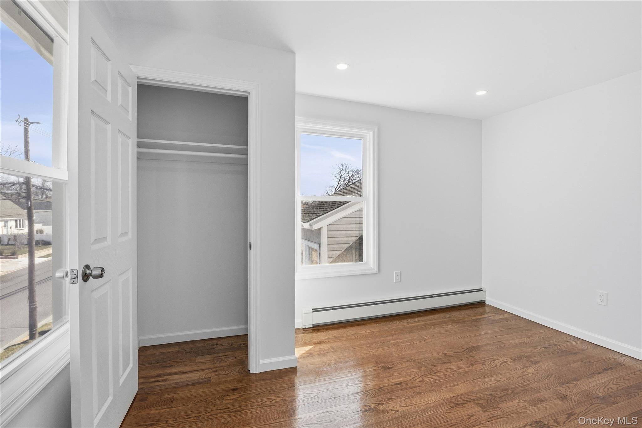 22 Colonial Avenue Freeport, NY 11520 - Photo 37 of 41 a view of an empty room with wooden floor and a window