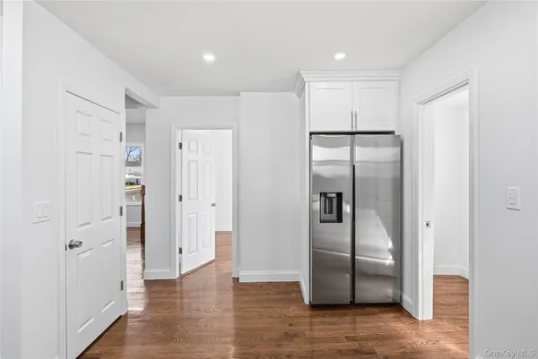 a view of a refrigerator in kitchen and wooden floor