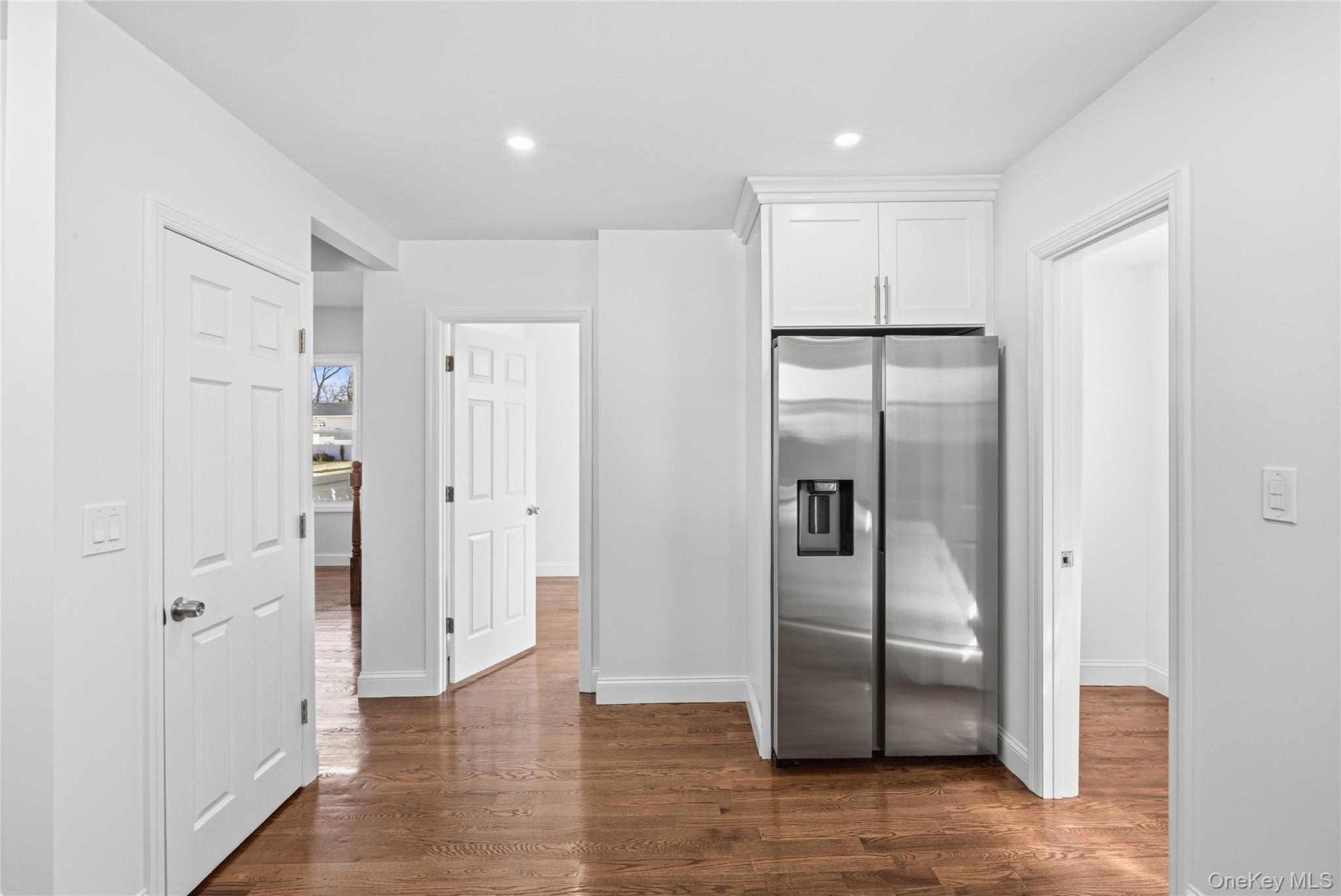 22 Colonial Avenue Freeport, NY 11520 - Photo 4 of 41 a view of a refrigerator in kitchen and wooden floor