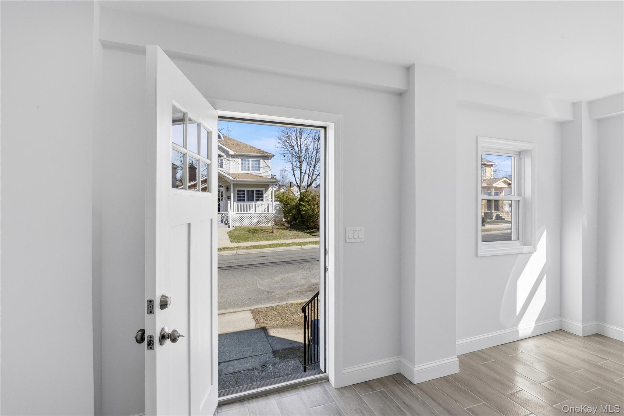 22 Colonial Avenue Freeport, NY 11520 - Photo 5 of 41 a view of a hallway with wooden floor and a livingroom