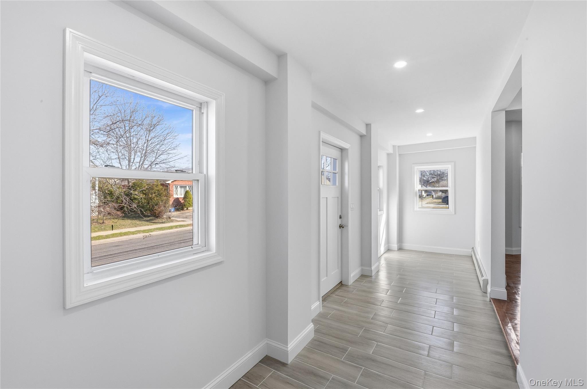 22 Colonial Avenue Freeport, NY 11520 - Photo 6 of 41 a view of a hallway with wooden floor and a workspace