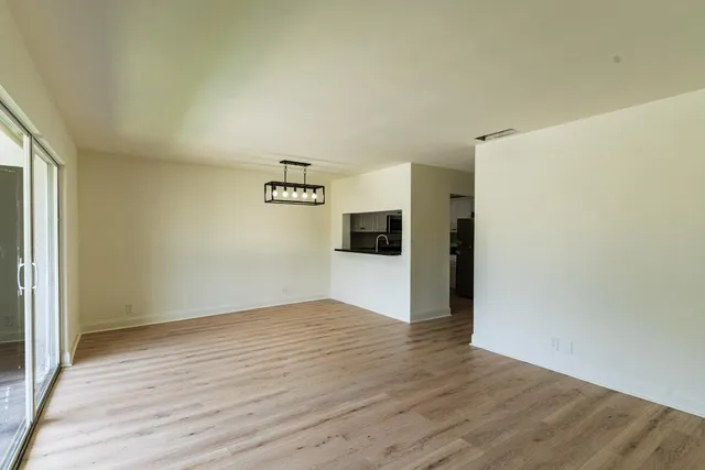 a view of a kitchen with wooden floor