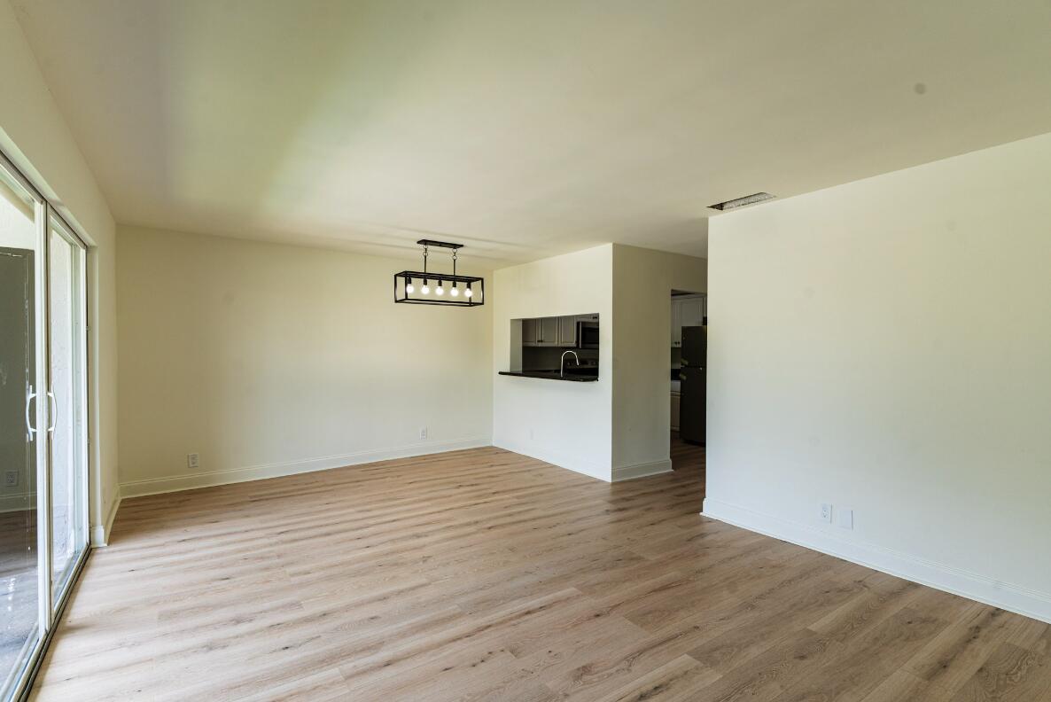 5458 Via Delray Boulevard, Unit 110 Delray Beach, FL 33484 - Photo 13 of 30 a view of a kitchen with wooden floor