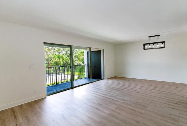 a view of an empty room with glass door