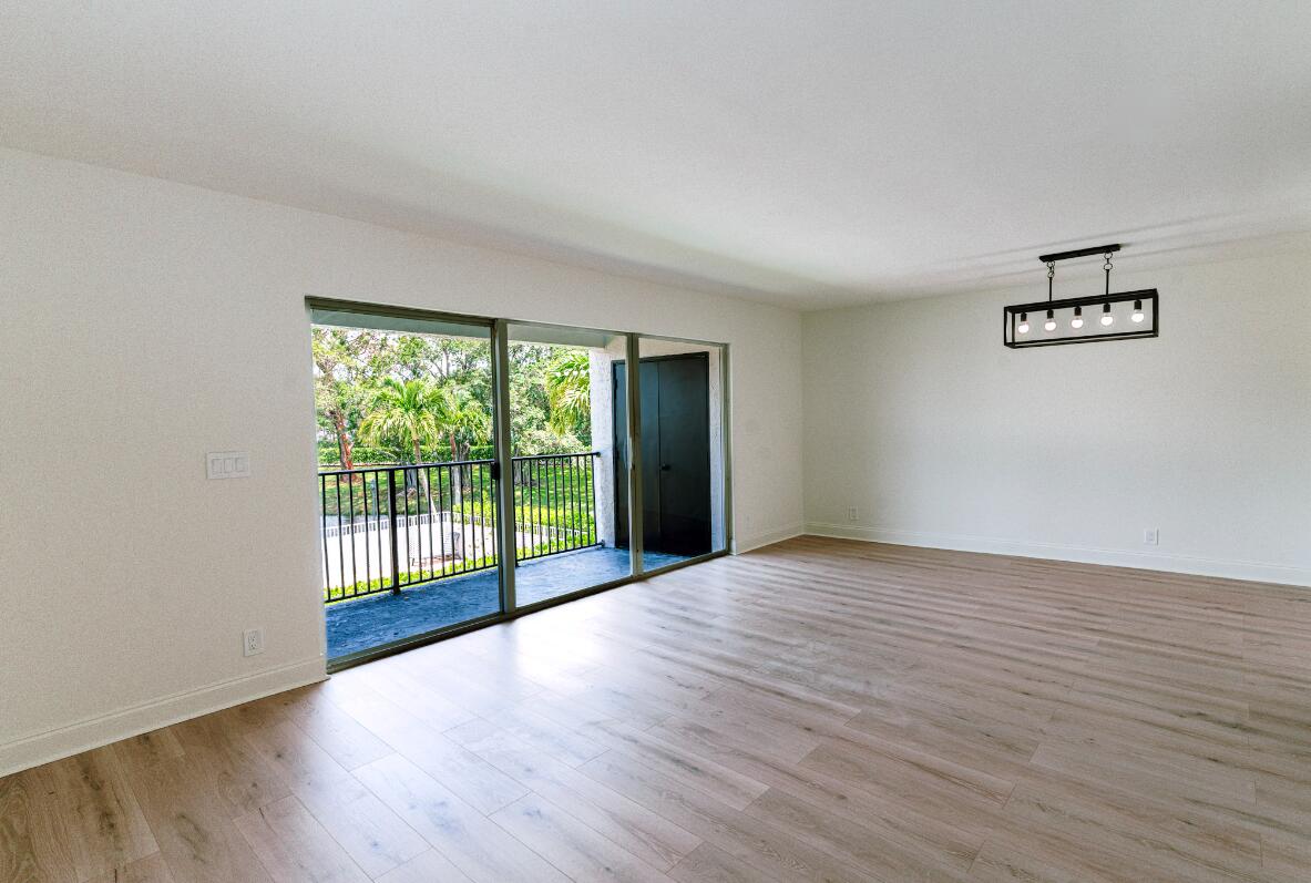 5458 Via Delray Boulevard, Unit 110 Delray Beach, FL 33484 - Photo 16 of 30 a view of an empty room with glass door