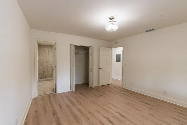 a view of hallway with wooden floor