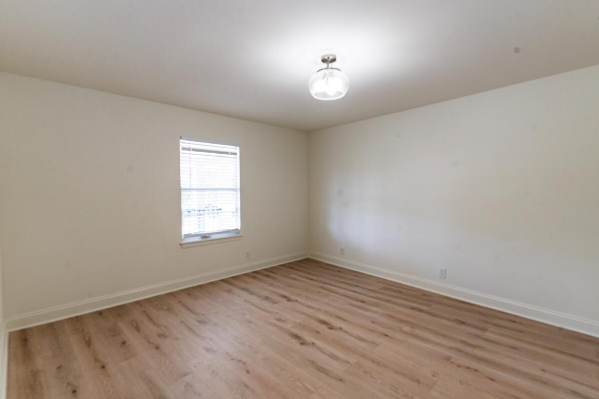 5458 Via Delray Boulevard, Unit 110 Delray Beach, FL 33484 - Photo 20 of 30 an empty room with wooden floor and windows