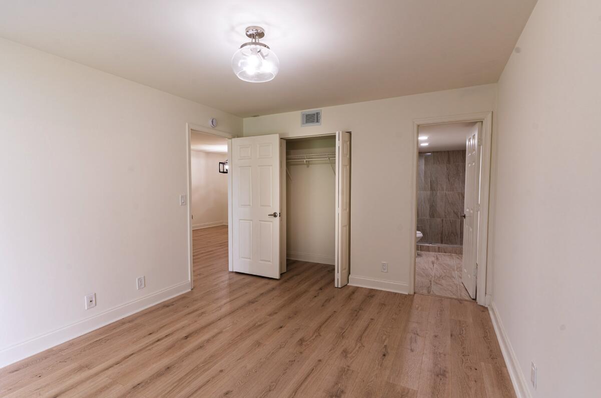 5458 Via Delray Boulevard, Unit 110 Delray Beach, FL 33484 - Photo 25 of 30 wooden floor in an empty room with a window