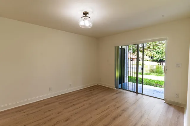 a view of a room with wooden floor and iron gate