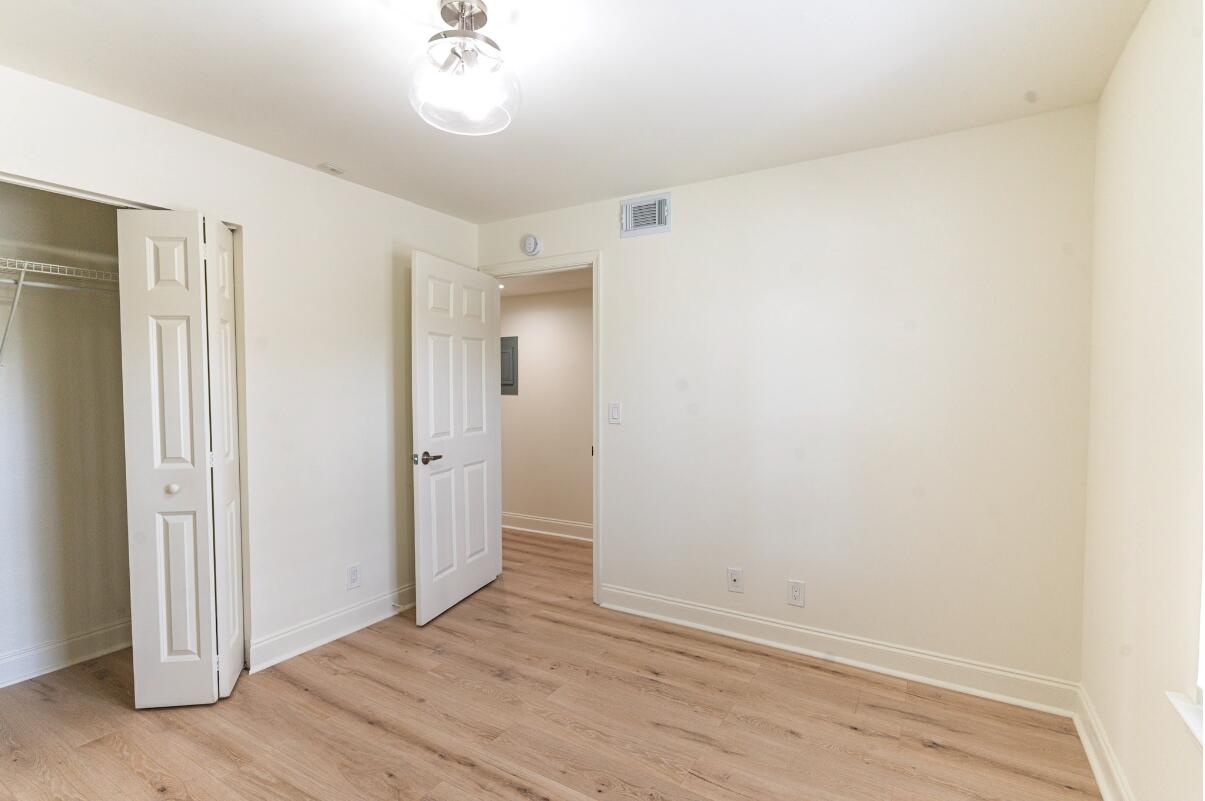 5458 Via Delray Boulevard, Unit 110 Delray Beach, FL 33484 - Photo 27 of 30 a view of a room with wooden floor and a bathroom