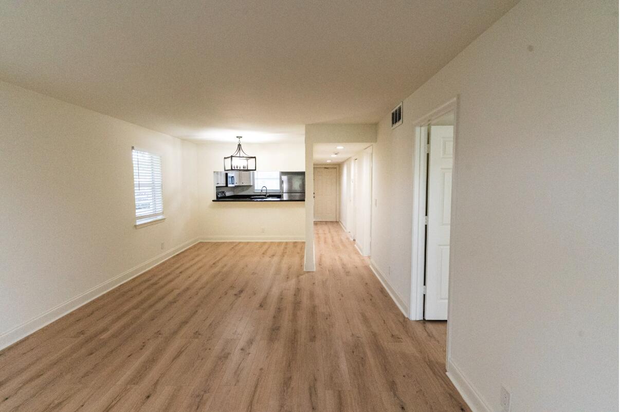 5458 Via Delray Boulevard, Unit 110 Delray Beach, FL 33484 - Photo 6 of 30 a view of a room with wooden floor and a window