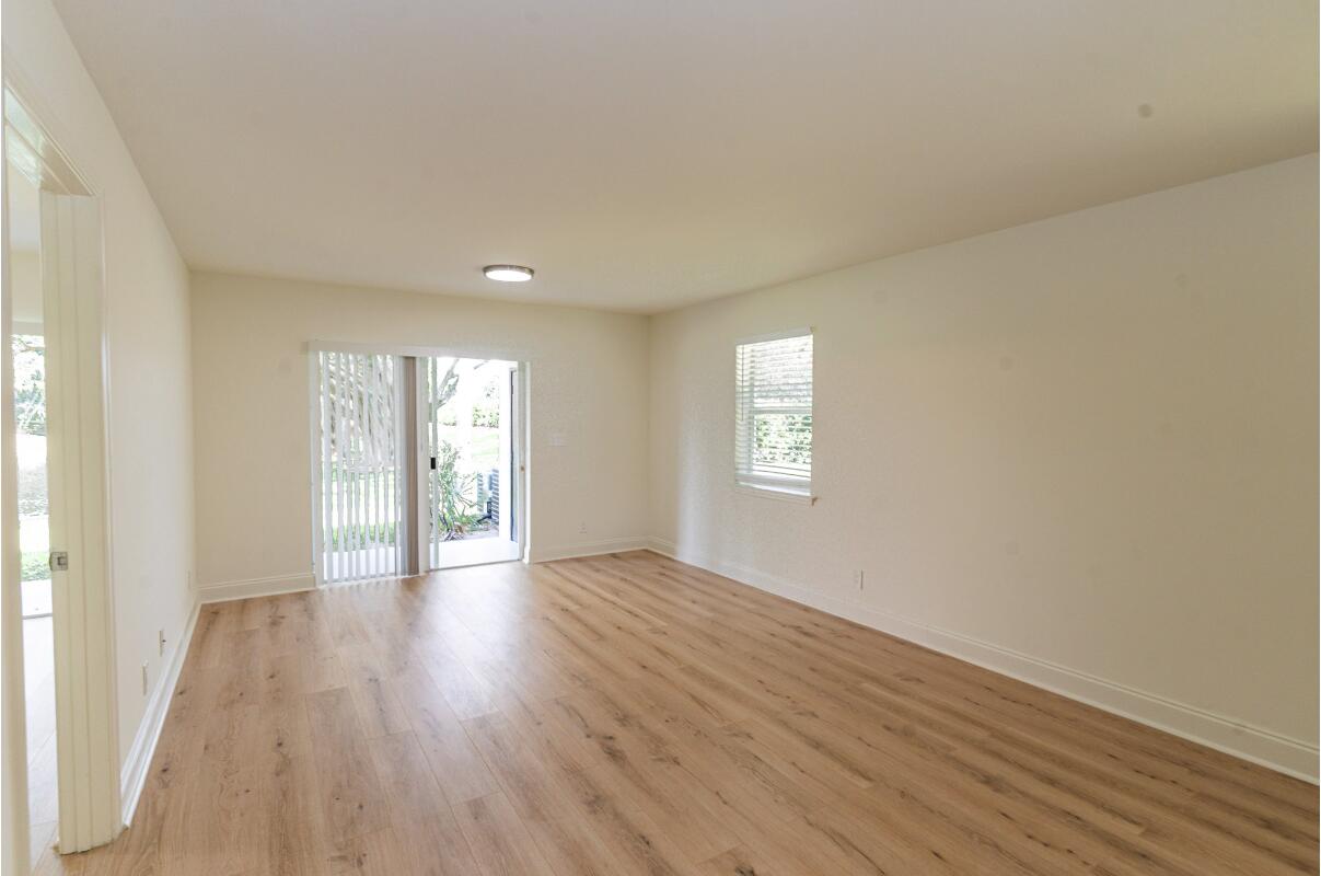 5458 Via Delray Boulevard, Unit 110 Delray Beach, FL 33484 - Photo 7 of 30 wooden floor in an empty room with a window