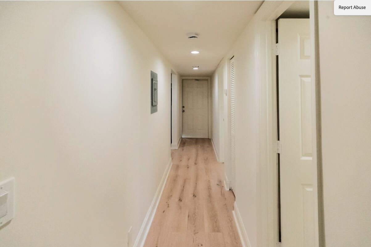 5458 Via Delray Boulevard, Unit 110 Delray Beach, FL 33484 - Photo 8 of 30 a view of a hallway with wooden floor and a bathroom