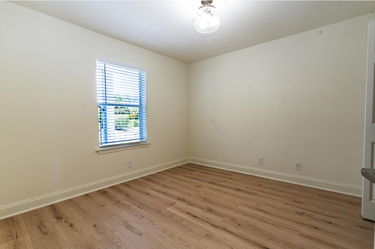 5458 Via Delray Boulevard, Unit 110 Delray Beach, FL 33484 - Photo 9 of 30 wooden floor in an empty room with a window