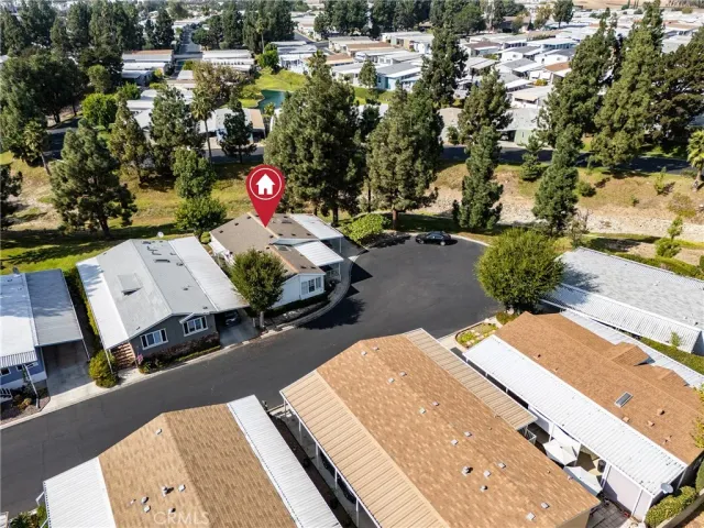 an aerial view of a house with a yard basket ball court and outdoor seating