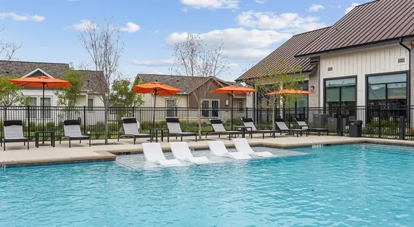 a view of swimming pool with outdoor seating and a potted plant