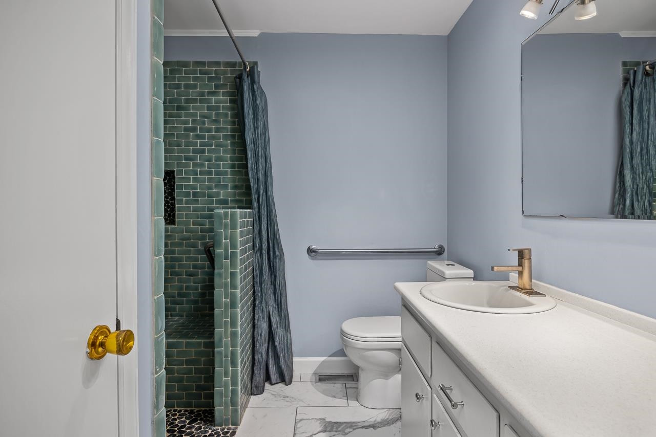 5815 Paragon Circle Durham, NC 27712 - Photo 14 of 41 a bathroom with a sink toilet and shower