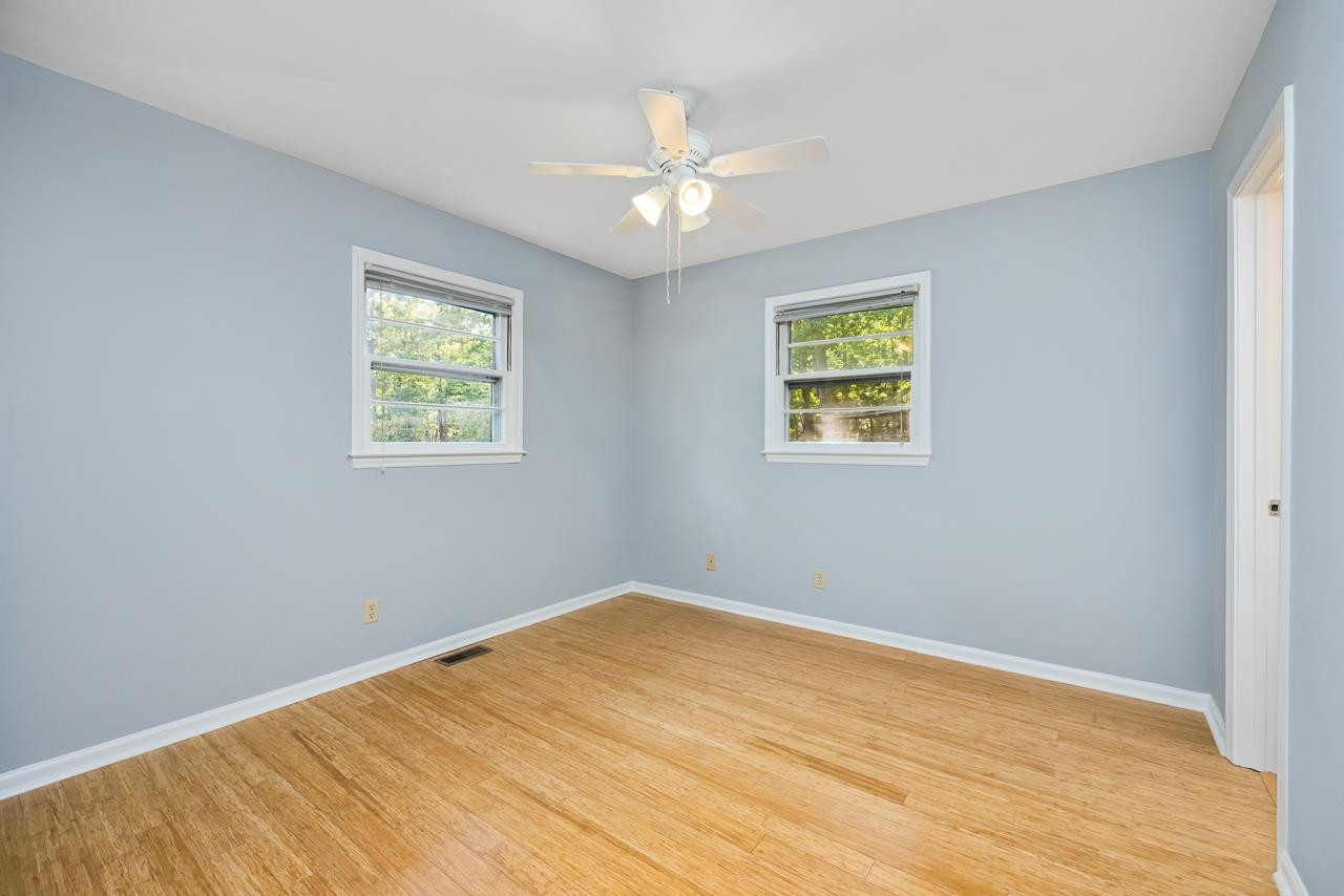 5815 Paragon Circle Durham, NC 27712 - Photo 16 of 41 a view of empty room with wooden floor