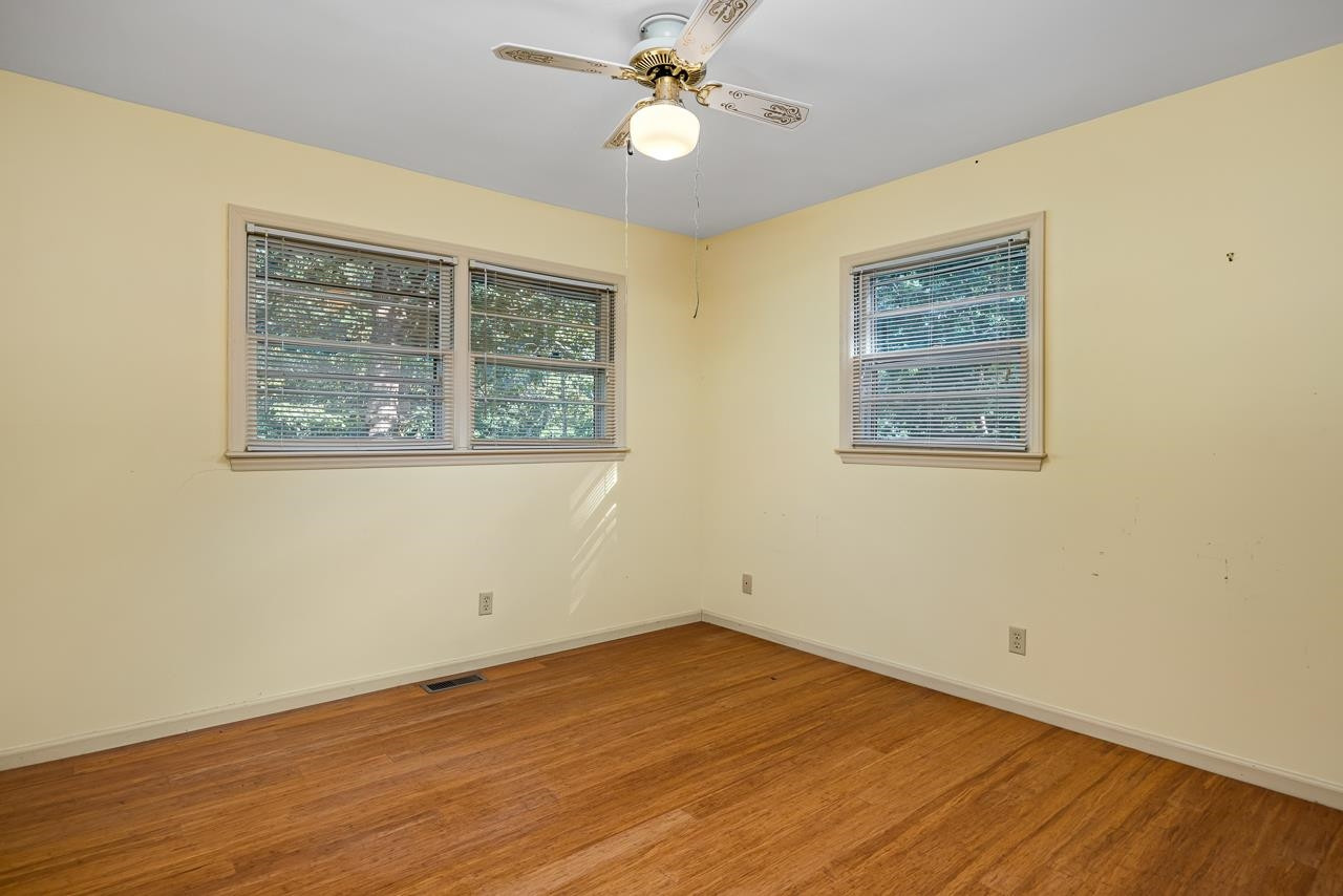 5815 Paragon Circle Durham, NC 27712 - Photo 18 of 41 a view of an empty room with wooden floor and a window