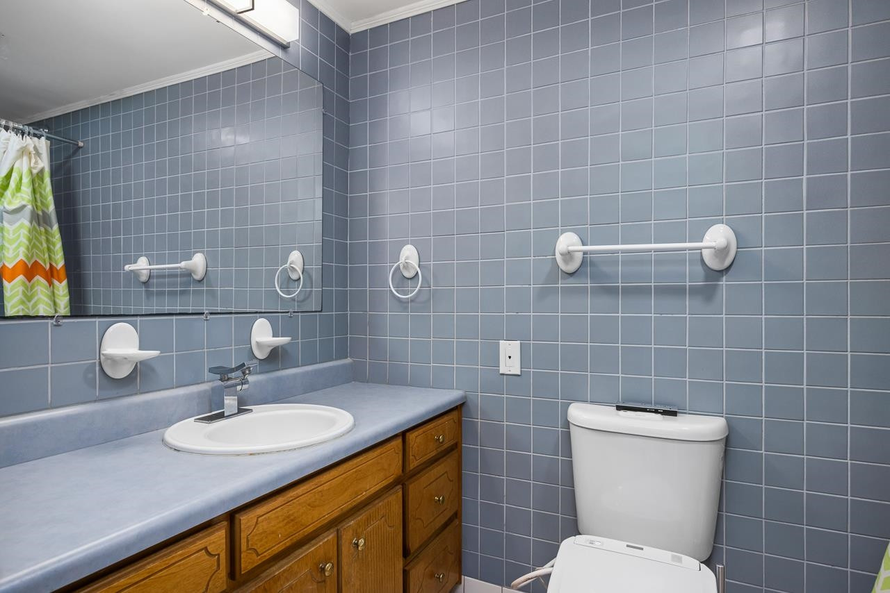 5815 Paragon Circle Durham, NC 27712 - Photo 19 of 41 a bathroom with a sink a toilet and a mirror