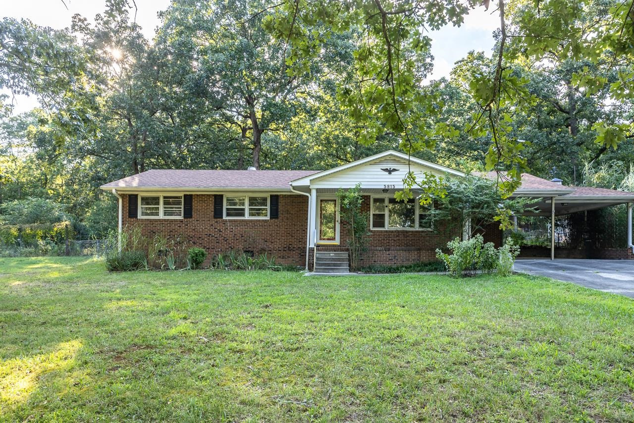 5815 Paragon Circle Durham, NC 27712 - Photo 3 of 41 a front view of a house with a yard and garage