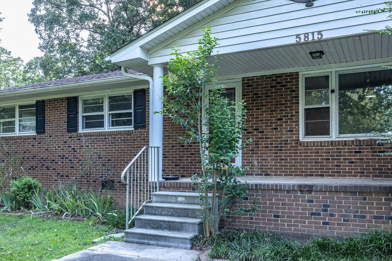 5815 Paragon Circle Durham, NC 27712 - Photo 5 of 41 a front view of a house with a garden