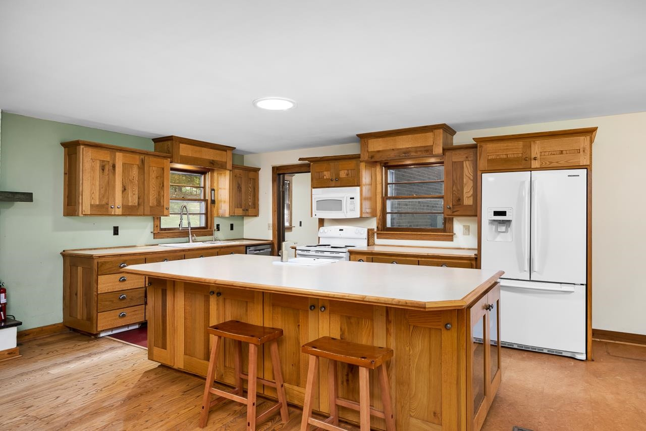 5815 Paragon Circle Durham, NC 27712 - Photo 7 of 41 a kitchen with stainless steel appliances granite countertop a sink and a refrigerator