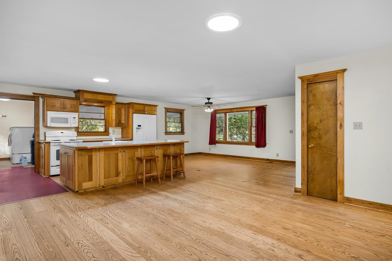 5815 Paragon Circle Durham, NC 27712 - Photo 8 of 41 an empty room with wooden floor and entrance to ceiling window